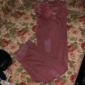 ripped colored jeans with fold at bottom